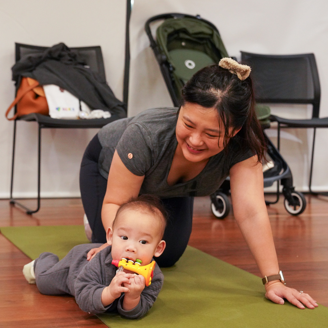Woman and baby on yoga mat